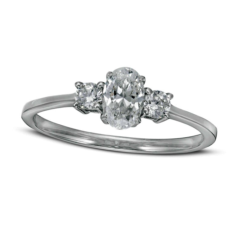 0.63 CT. T.W. Oval and Round Natural Diamond Three Stone Engagement Ring in Solid 14K White Gold