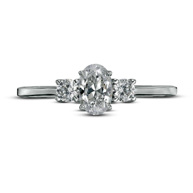 0.63 CT. T.W. Oval and Round Natural Diamond Three Stone Engagement Ring in Solid 14K White Gold