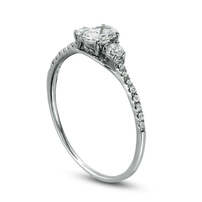 0.63 CT. T.W. Oval and Round Natural Diamond Three Stone Engagement Ring in Solid 14K White Gold