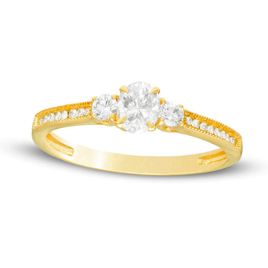 0.63 CT. T.W. Oval and Round Natural Diamond Three Stone Engagement Ring in Solid 14K Gold