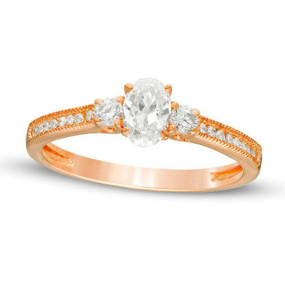 0.63 CT. T.W. Oval and Round Natural Diamond Three Stone Engagement Ring in Solid 14K Rose Gold
