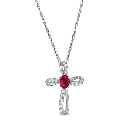 Oval Ruby and 0.1 CT. T.W. Natural Diamond Pinwheel Cross Pendant in 10K White Gold