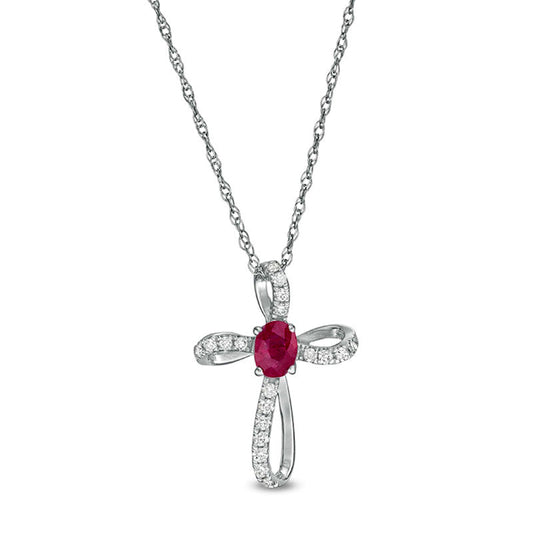 Oval Ruby and 0.1 CT. T.W. Natural Diamond Pinwheel Cross Pendant in 10K White Gold