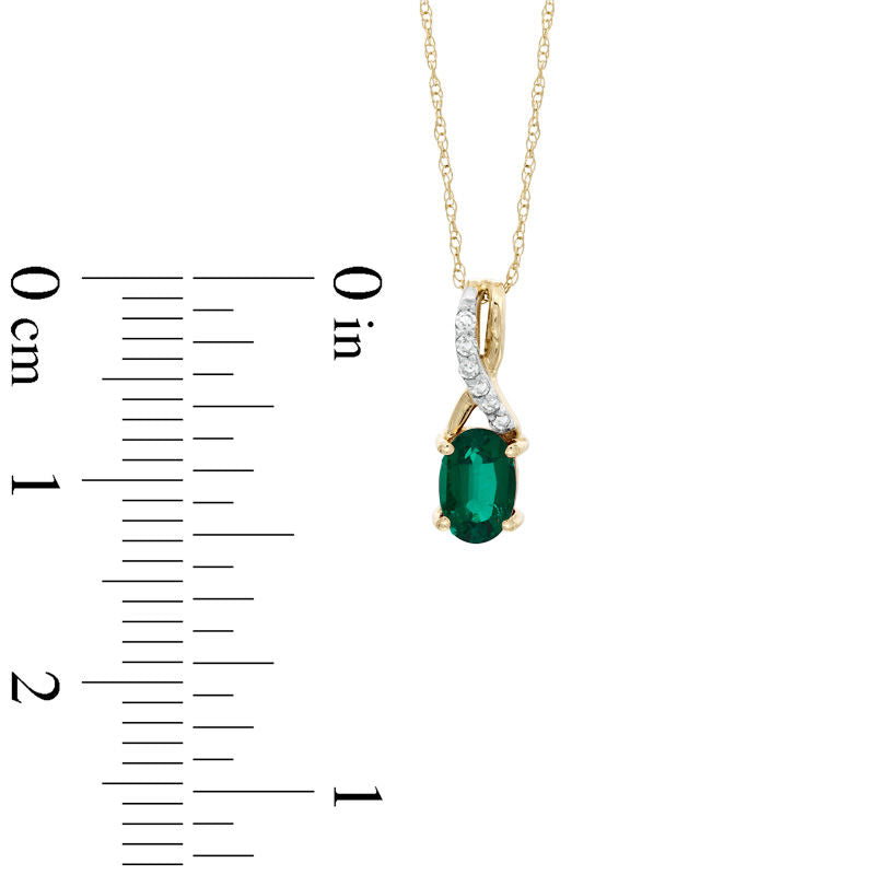 Oval Lab-Created Emerald and Diamond Accent Twist Pendant in 10K Yellow Gold