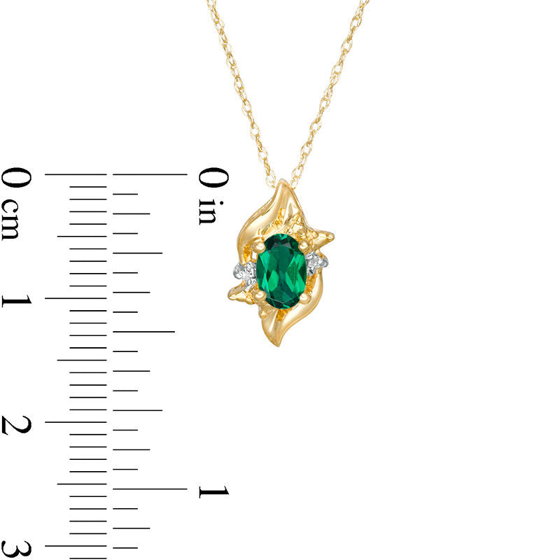 Oval Lab-Created Emerald and Diamond Accent Flame Burst Pendant in 10K Yellow Gold