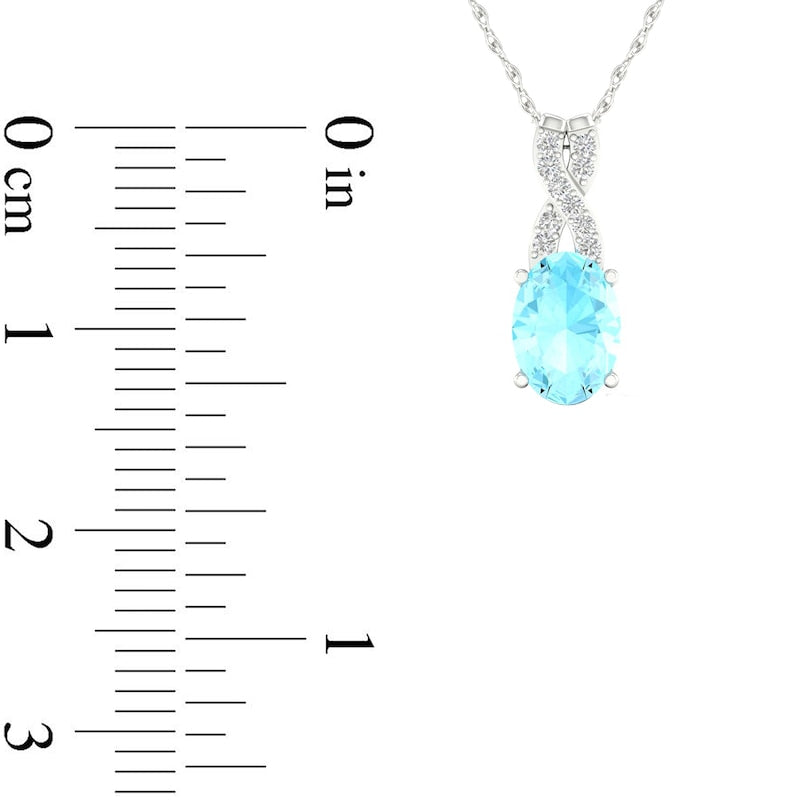 Oval Aquamarine and 0.05 CT. T.W. Natural Diamond X" Drop Pendant in 10K White Gold"