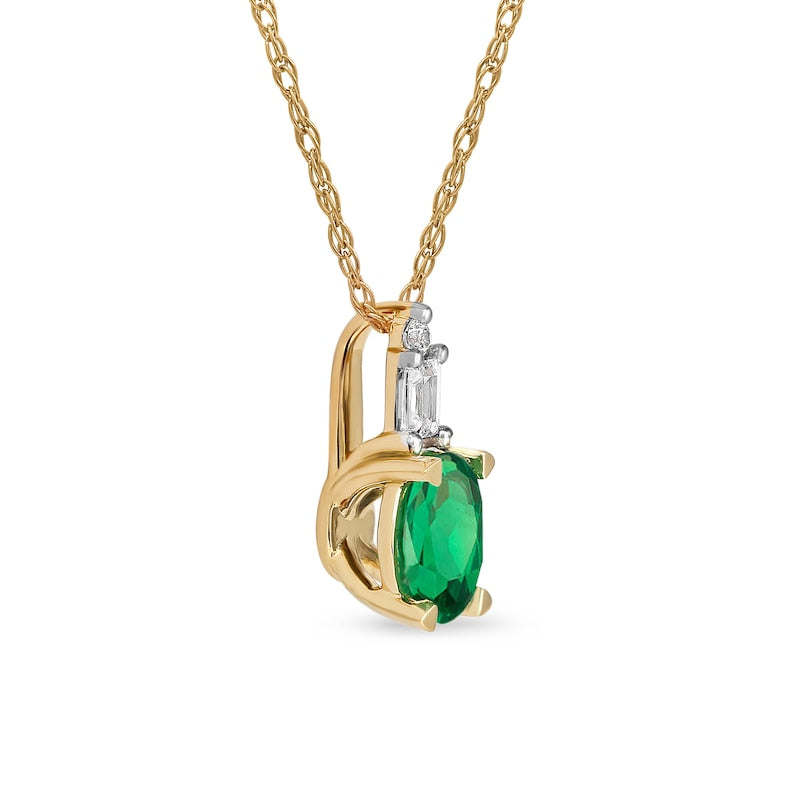 Oval Emerald and 0.05 CT. T.W. Baguette and Round Natural Diamond Stacked Top Accent Pendant in 10K Yellow Gold