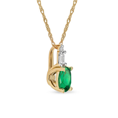 Oval Emerald and 0.05 CT. T.W. Baguette and Round Natural Diamond Stacked Top Accent Pendant in 10K Yellow Gold