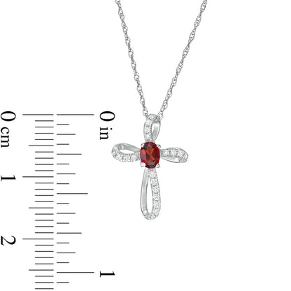 Oval Garnet and 0.1 CT. T.W. Natural Diamond Pinwheel Cross Pendant in 10K White Gold